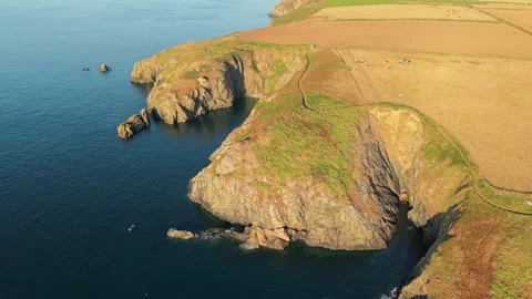 Rocky Cliffs and Coastal Path Above Irish Sea, Pembrokeshire, Aerial Orbit Stock-Footage 343752805