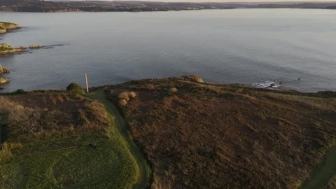Rocky cliffs and ocean waves at dusk Stock Footage 322908254