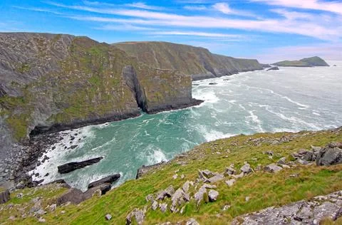 Rocky cliffs and waves on dramatic coastline 스톡 사진