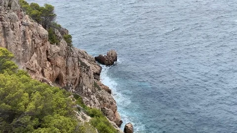 Rocky cliffs in a bay in Mallorca Stock Footage 114707715