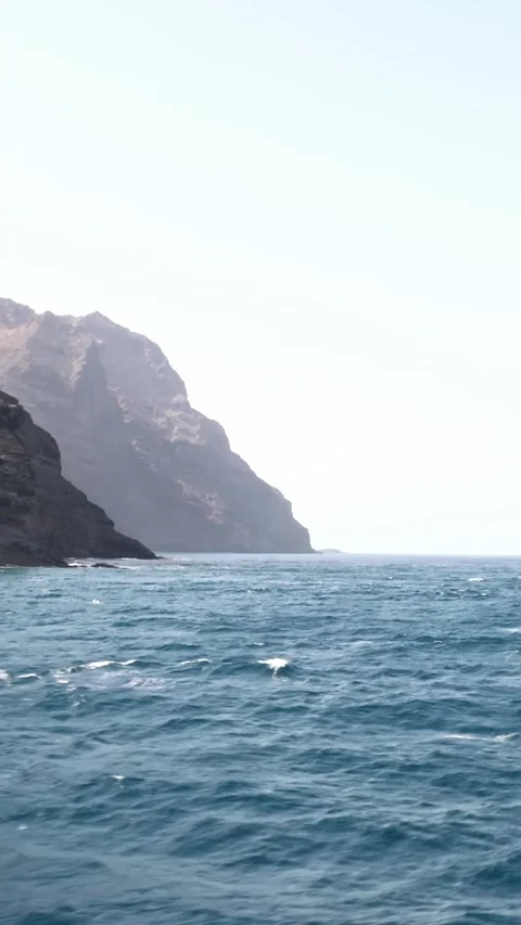 Rocky cliffs on the coast at La Gomera island, closeup shot zoom out Stock Footage 250249186