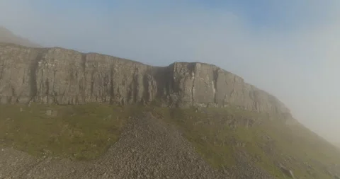 Rocky cliffs emerge from mist Stock Footage 296654020