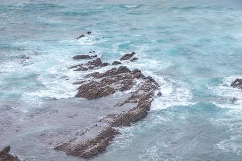 Rocky cliffs with futuristic patterns on the Atlantic coast near the town of  Stock Photos