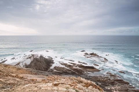 Rocky cliffs with futuristic patterns on the Atlantic coast near the town of  Stock Photos