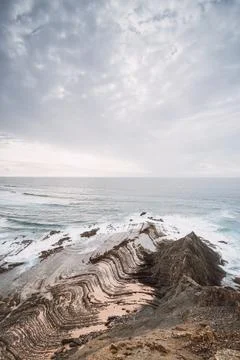Rocky cliffs with futuristic patterns on the Atlantic coast near the town of  Stock Photos
