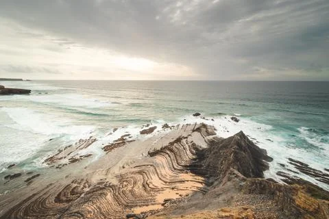 Rocky cliffs with futuristic patterns on the Atlantic coast near the town of  Stock Photos