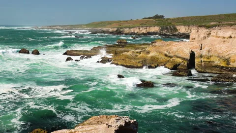 Rocky cliffs by the ocean, view from bluffs, beautiful dramatic seascape Stock Footage 154049013