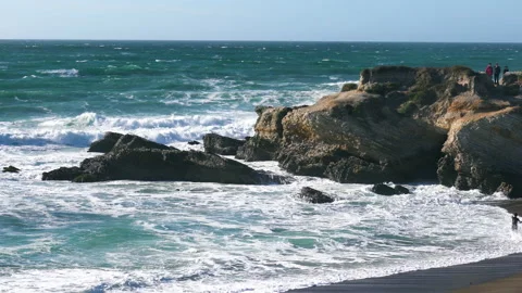  Rocky cliffs, sandy beach, and people enjoying beautiful sunny day. Stock Footage 150022377