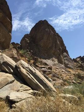 Rocky Cliffs Under a Bright Blue Sky in a Serene Desert Landscape Stock Photos
