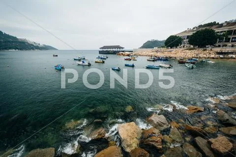 Rocky coast and boats at Stanley, on Hong Kong Island, Hong Kong. Stock Photos