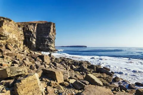 Rocky coast and high cliffs of Tobizin Cape in winter, Vladivostok, Russia Stock Photos