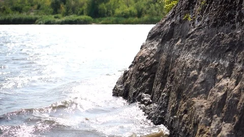 Rocky coast with bumping waves into it Stock Footage 120873017