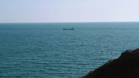 Rocky coast of the ocean overlooking the ship Stock Footage 84005621