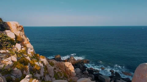 Rocky Coastal Cliff Facing Deep Blue Ocean Waves Video stock 340464003
