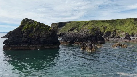 Rocky Coastal Cliffs at Ballydwan Beach Waterford Ireland Видео 337396969