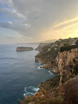 Rocky coastline at sunset with dramatic sky Stock Photos