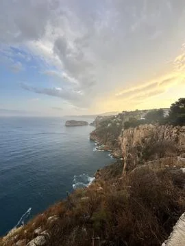 Rocky coastline at sunset with dramatic sky Stock Photos