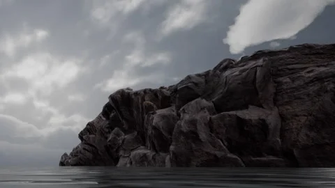 Rocky coastline under cloudy sky with calm water in the background Stock Footage 340023312