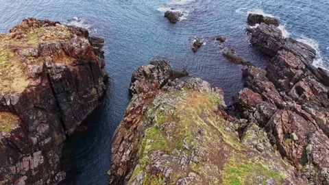 Rocky coastline view with ocean waves and natural landscape detail Stockbeeldmateriaal 335143137