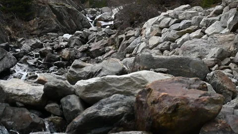 Rocky dam blocks cascading mountain stream focus pull Video stock 234729620