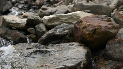 Rocky dam in mountain stream camera tilt up Stock Footage 234728618
