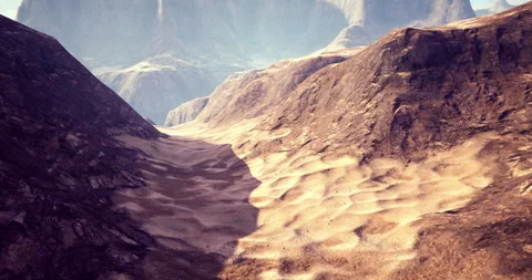 Rocky desert landscape with dramatic shadows and mountains in background Stock Footage 305695175