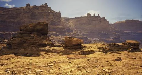 Rocky desert landscape with towering cliffs under clear blue sky Stock Illustration