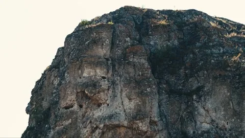 Rocky Formation with Dramatic Texture and Overcast Sky highlights the rugged Stock Footage 280031597