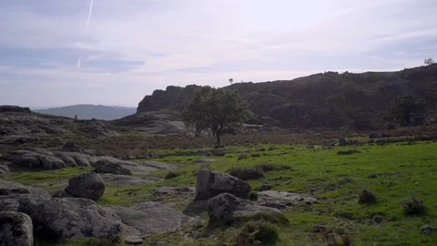 Rocky hill landscape with cloudy blue sky in background, Portugal Stock Footage 129067524