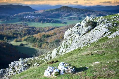 Rocky hillside with panoramic view of rolling hills and autumn forests Stock Photos
