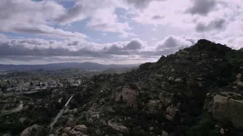 Rocky Hillside Train Passing Dramatic Clouds A Stock Footage 242040217