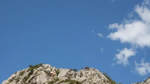 Rocky hilltop clouds timelapse Stock Footage 93413626