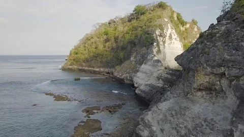 Rocky island in the ocean with the sky reflection aerial footage of Indonesia Stock Footage 101993015