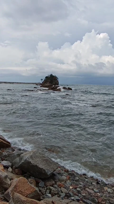 Rocky Island Ocean Waves Cloudy Sky Video stock 333606841