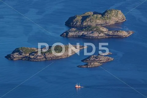 Rocky islands in norwegian sea Stock Photos