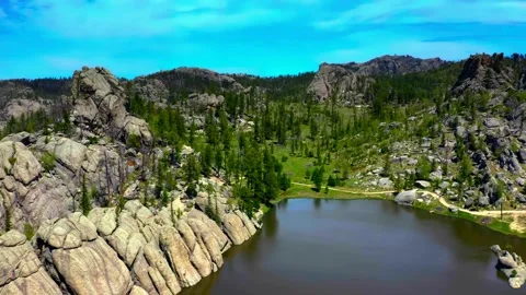Rocky lake landscape with pine forest and clear water Stock Footage 340962477