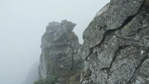 Rocky landscape on alpine meadows on a cloudy day. Fog in the mountains Stock Footage 228732071