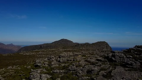 Rocky Landscape On Flat Mountain Range [Drone Footage] Stock Footage 88819792