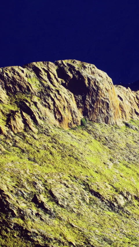 Rocky landscape under a clear sky with green patches and rugged stones Stock Footage 334261611