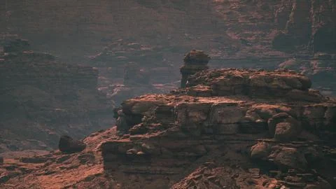 Rocky landscape with unique formations under dramatic lighting at dusk Stock Illustration