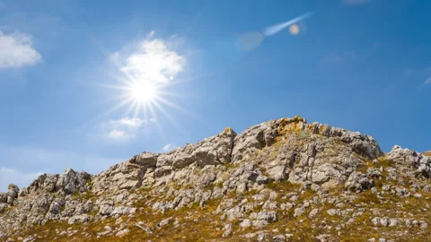 Rocky mount top under a sparkle sun Stock Footage 328239437