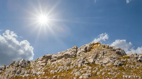 Rocky mount top under a sparkle sun, natural outdoor scene Видео 343606269