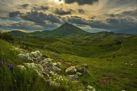 Rocky mountain with a dramatic cloudy sky Stock Footage 133501305
