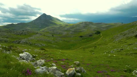 Rocky mountain with a dramatic cloudy sky Stock Footage 133629295