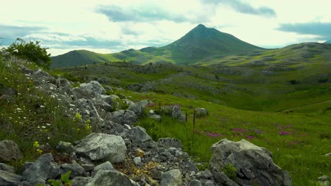 Rocky mountain with a dramatic cloudy sky Stock Footage 133629879