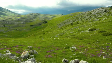 Rocky mountain with a dramatic cloudy sky Stock Footage 133817077