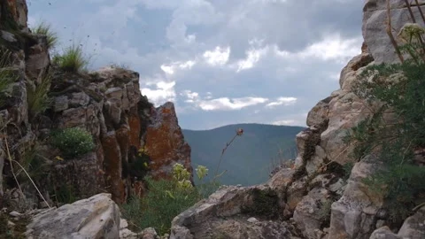 Rocky mountain dramatic view with overcast cloudy sky. closeup. Stock Footage 319812740