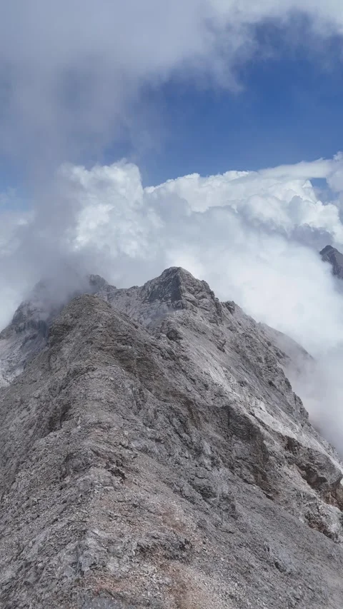 Rocky Mountain Peak Ascending Through Clouds in Bavaria, Germany Video stock 335969216