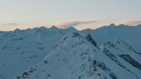 A rocky mountain peak is lit by the first sun of the day Stock Footage 101913266