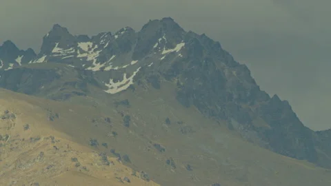 Rocky mountain peak with a tiny bit of snow Stock Footage 159750851
